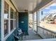 A cozy covered front porch features two chairs, white railings, and an inviting atmosphere at 5121 Windmere Chase Dr, Raleigh, NC 27616