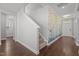 Hallway with stairs, decorative wallpaper, wood flooring and natural light at 5121 Windmere Chase Dr, Raleigh, NC 27616