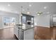 Bright and open kitchen with stainless steel appliances, a granite island, and hardwood floors at 5121 Windmere Chase Dr, Raleigh, NC 27616