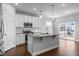 An open kitchen showcases white cabinetry, an island, and stainless steel appliances at 5121 Windmere Chase Dr, Raleigh, NC 27616