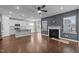Open-concept living room with a fireplace, hardwood floors, and stainless steel appliances at 5121 Windmere Chase Dr, Raleigh, NC 27616