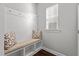 Mudroom with a built-in bench, coat hooks, storage cubbies, and natural light at 5121 Windmere Chase Dr, Raleigh, NC 27616