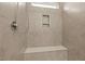 Tiled shower interior featuring a built-in seat and a recessed niche for toiletries at 5121 Windmere Chase Dr, Raleigh, NC 27616