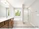 Bathroom featuring a double vanity, bathtub and shower combination and a large window for abundant natural light at 5372 Salem Woods Dr # 18, Graham, NC 27253