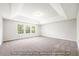 Bright bedroom featuring neutral carpet, ample light through a bank of windows, and calming, neutral walls at 5372 Salem Woods Dr # 18, Graham, NC 27253