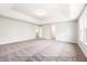 Spacious bedroom with tray ceiling, plush carpet, and natural light; customizable for relaxation and comfort at 5372 Salem Woods Dr # 18, Graham, NC 27253