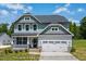 Charming two-story home with a covered front porch and an attached two-car garage at 5372 Salem Woods Dr # 18, Graham, NC 27253