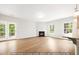 Bright and airy living area with hardwood floors, fireplace, and access to outdoor deck at 5372 Salem Woods Dr # 18, Graham, NC 27253