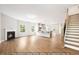 Open concept living area featuring fireplace, staircase, and hardwood floors at 5372 Salem Woods Dr # 18, Graham, NC 27253