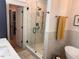 Contemporary bathroom featuring a glass-enclosed shower, soaking tub, and modern fixtures at 582 Harnett Central Rd, Fuquay Varina, NC 27526