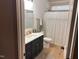 Bathroom featuring a shower/tub combo, modern vanity, and stylish fixtures at 582 Harnett Central Rd, Fuquay Varina, NC 27526