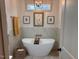 Relax in this luxurious bathroom featuring a freestanding tub, modern fixtures, and elegant decor at 582 Harnett Central Rd, Fuquay Varina, NC 27526