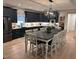 Spacious kitchen featuring dark cabinets, granite countertops, and large dining table at 582 Harnett Central Rd, Fuquay Varina, NC 27526