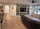 Open-concept living room with built-in shelving, a fireplace, and access to the kitchen at 582 Harnett Central Rd, Fuquay Varina, NC 27526