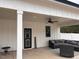 Inviting outdoor space with ample seating, fan, and door at 582 Harnett Central Rd, Fuquay Varina, NC 27526