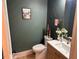 Stylish powder room with shiplap wall, modern fixtures, and wood-look vanity at 582 Harnett Central Rd, Fuquay Varina, NC 27526