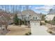 A stunning two-story home showcases a two-car garage, pristine landscaping, and a spacious driveway at 6205 Roles Saddle Dr, Rolesville, NC 27571