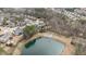 Overhead view of a neighborhood pond, showcasing the surrounding homes and wooded area at 6205 Roles Saddle Dr, Rolesville, NC 27571