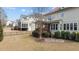 Backyard view of the home with a screened-in porch and well-kept landscaping at 6205 Roles Saddle Dr, Rolesville, NC 27571