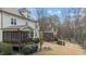 A backyard featuring a screened porch, well-maintained landscaping, and a black metal fence at 6205 Roles Saddle Dr, Rolesville, NC 27571