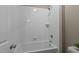 Clean white tiled tub and shower combination with new showerhead at 6205 Roles Saddle Dr, Rolesville, NC 27571