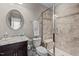 Tiled bathroom with a glass-enclosed shower, vanity and a towel rack at 6205 Roles Saddle Dr, Rolesville, NC 27571