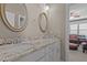 Bathroom with double sink vanity, granite countertop, and oval mirrors at 6205 Roles Saddle Dr, Rolesville, NC 27571