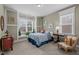 Bedroom with a bed, a chair, and two windows letting in lots of natural light at 6205 Roles Saddle Dr, Rolesville, NC 27571