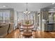 Dining area features a chandelier, windows, and is adjacent to the kitchen and living room at 6205 Roles Saddle Dr, Rolesville, NC 27571