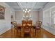 Chic dining room with coffered ceilings, chandelier, and a round dining table with seating for four at 6205 Roles Saddle Dr, Rolesville, NC 27571