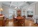An inviting dining room with coffered ceilings, chandelier, and a table with seating for four at 6205 Roles Saddle Dr, Rolesville, NC 27571
