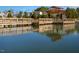 A serene lake view featuring a wooden dock with railings and a covered pavilion for relaxing by the water at 6205 Roles Saddle Dr, Rolesville, NC 27571
