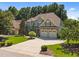Beautiful two-story home showcasing a well-manicured lawn, three-car garage, and traditional design at 6205 Roles Saddle Dr, Rolesville, NC 27571