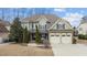 A gorgeous two-story home featuring a two-car garage, stone accents, and a well-manicured lawn at 6205 Roles Saddle Dr, Rolesville, NC 27571