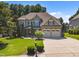 Beautiful two-story home with a well-kept lawn and two-car garage on a sunny day at 6205 Roles Saddle Dr, Rolesville, NC 27571