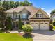 A charming two-story home with stone accents, a manicured lawn, and a classic architectural style at 6205 Roles Saddle Dr, Rolesville, NC 27571