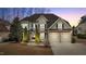 Charming two-story home featuring a two-car garage, manicured lawn, and covered front entryway at 6205 Roles Saddle Dr, Rolesville, NC 27571