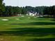 Expansive green golf course with multiple sand traps and surrounding trees and residential neighborhood at 6205 Roles Saddle Dr, Rolesville, NC 27571