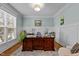 A stylish home office with natural light, wainscoting, and a hardwood floor at 6205 Roles Saddle Dr, Rolesville, NC 27571