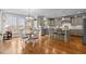 Open kitchen and dining area with hardwood floors, light gray cabinets, and lots of natural light at 6205 Roles Saddle Dr, Rolesville, NC 27571