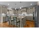 Spacious kitchen with a large island, stainless steel appliances, and light gray cabinets at 6205 Roles Saddle Dr, Rolesville, NC 27571