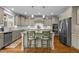 Modern kitchen with an island, stainless steel appliances, and light gray cabinets at 6205 Roles Saddle Dr, Rolesville, NC 27571