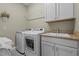 Clean and efficient laundry room with washer, dryer, sink and storage at 6205 Roles Saddle Dr, Rolesville, NC 27571