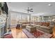 Bright living room with a large sectional couch, hardwood floors, and a fireplace with mantle at 6205 Roles Saddle Dr, Rolesville, NC 27571