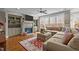 Spacious living room with a large sectional couch, hardwood floors, and a fireplace with built-in shelves at 6205 Roles Saddle Dr, Rolesville, NC 27571