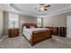 Bright main bedroom with a wooden sleigh bed and tan carpet at 6205 Roles Saddle Dr, Rolesville, NC 27571