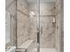 A glass shower with tile design and built in shower bench at 6205 Roles Saddle Dr, Rolesville, NC 27571