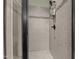 Close-up of a shower featuring tiled walls with decorative accents and modern fixtures at 6205 Roles Saddle Dr, Rolesville, NC 27571