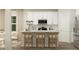 Modern kitchen with white cabinets, stainless steel appliances, and a stylish breakfast bar at 704 Shea Hill Dr, Angier, NC 27501