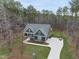 Aerial view of a beautiful property showcasing the home's layout, driveway, and surrounding landscape at 85 Willow Bend Dr, Youngsville, NC 27596
